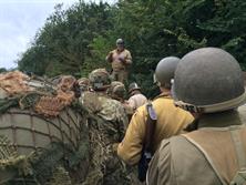 FIRST SGT. EXPLAINING THE DAY'S ADVENTURES TO US FIRST SGT. EXPLAINING THE DAY'S ADVENTURES TO US