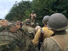 FIRST SGT. EXPLAINING THE DAY'S ADVENTURES TO US