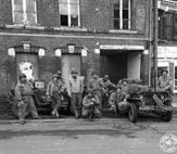 82ND RECON IN FRONT OF THEIR BOMBED OUT HOUSE IN BRAY-SUR-SOMME 82ND RECON IN FRONT OF THEIR BOMBED OUT HOUSE IN BRAY-SUR-SOMME